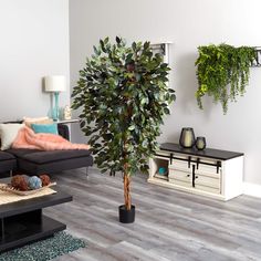 a living room filled with furniture and a tree in the middle of it's center