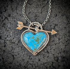 Genuine Kingman, Arizona turquoise heart is set in a handcrafted oxidized 925 sterling silver bezel with accents of 14k gold. Front closing arrow toggle closure features a Moissanite diamond for a touch of sparkle. Connects  to a 2.2mm medium weight and sturdy rolo chain.  ~Turquoise D 24mm x 28mm (Large size with inclusions of pyrite) ~Turquoise E 28mm x 34mm (Extra large size with tiny inclusions of pyrite) ~Natural untreated American mined stones ~Wrapped in black gift box ~Handmade in Tennes Turquoise Heart Necklace, Turquoise Necklaces, Kingman Arizona, Gift Box Handmade, Turquoise Jewelry Native American, Turquoise Heart, Stone Wrapping, Arizona Turquoise, Box Handmade