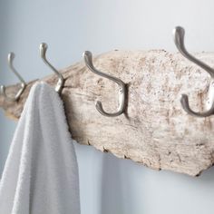 two hooks are hanging on the wall next to a towel