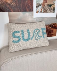 a pillow with the word sufc on it sitting in front of pictures and photos