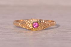 The Middlesborough: Child's Antique Ring in Yellow Gold. The ring centers on a pink crystal. Wrapping the flush set center stone and continuing down the sides is a simple engraving. The ring is crafted in 14 karat yellow gold and is a finger size 4 yet can be adjusted to any finger size for an additional charge on request. Love this piece, but don't have the money to spend right now?  We offer FREE layaway on every item in our shop.  With just 20% down, take one full year (interest-free) to pay Crystal Wrapping, Antique Ring, Pink Crystal, Antique Rings, The Money, Rings Statement, Statement Rings, Jewelry Rings, Etsy Accessories