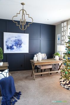 a living room with a christmas tree in the corner and other decorations on the wall