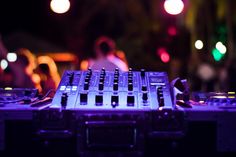 an electronic device is sitting in front of some blurry lights and people standing around