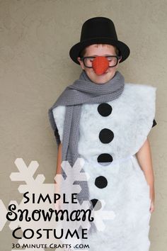 a young boy wearing a snowman costume with a nose and nose ring, standing in front of a wall