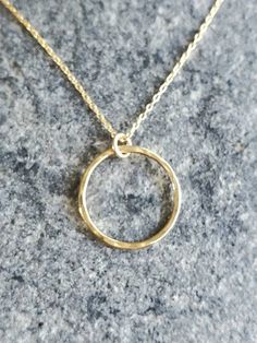 "This beautiful necklace has a handmade tiny gold circle. Perfect to wear every day. The circle measures 10mm across and it hangs on a 14K gold filled chain with a 14K gold filled clasp. Shown in 18\" length, but can be made as a long layering necklace also. Please choose length above. Also available in silver as shown in the last photo. *If you are unsure of the length you need, or would like to wear this item at different lengths, we now offer an adjustable length option! You can add an adjust Gold Circle Charm Necklace In Sterling Silver, Gold Circle Minimalist Charm Necklace, Minimalist Circle Charm Gold Necklace, Minimalist Gold Circle Charm Necklace, Everyday Yellow Gold Circle Charm Necklace, Circle Shaped Yellow Gold Charm Necklace For Gift, Circle Charm Necklace In Yellow Gold For Gift, Yellow Gold Circle Charm Necklace For Gift, Circle Charm Necklace In Yellow Gold Sterling Silver