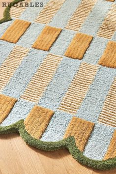 a close up of a rug on a wooden floor