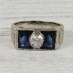 an antique style ring with blue and white stones