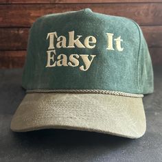 Vintage Style Take It Easy Embroidered Faded Canvas Snapback Trucker Rope Hat with Free Shipping. White stitched text/logo. Condition is "New with tags". Shipped with USPS First Class. Step into the world of the great outdoors with our Take It Easy Stitched Faded Canvas Rope Hat. With its faded canvas and rope accents, this hat exudes rustic charm. Plus, enjoy free shipping on this perfectly vintage-inspired accessory. *Condition is "New with tags". Shipped with USPS First Class. *This is a medi Vintage Snapback Baseball Cap With Letter Embroidery, Vintage Outdoor Baseball Cap With Embroidered Logo, Vintage Curved Brim Hat With Letter Embroidery, Vintage Letter Print Snapback Hat For Outdoor, Vintage Snapback Hat With Letter Print For Outdoor, Vintage Hat With Embroidered Logo, Vintage Adjustable Hat With Letter Embroidery, Vintage Adjustable Snapback Hat With Embroidered Logo, Embroidered Trucker Hat