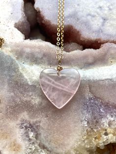 Pretty in pink. This large rose quartz crystal heart pendant necklace is the perfect healing piece to add to your jewelry collection. Exuding dusty soft shades of pink, rose quartz helps soothe your heart and emit love to those all around you. Embrace the delightful beauty and tranquil benefits of this gentle and graceful creation.    Pink Rose Quartz Crystal Pendant Necklace *Beautifully polished rose quartz *Soft and feminine style *Loving calm energy -- speaks directly to your heart chakra *1 Rose Quartz Heart Pendant, Pink Gemstone Heart Necklace For Gift, Pink Gemstone Heart Necklace Gift, Pink Heart Gemstone Necklace For Gift, Pink Heart Gemstone Pendant Necklace, Pink Gemstone Heart Necklace, Spiritual Rose Gold Heart Jewelry, Spiritual Heart-shaped Rose Gold Jewelry, Pink Rose Quartz Crystal Necklace With Natural Stones