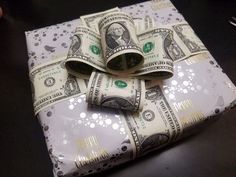 money wrapped in white paper on top of a table