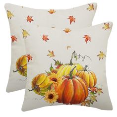 two white pillows with pumpkins and leaves on the pillow cover, one is yellow