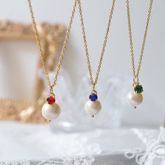 ♥ Dainty Freshwater Pearl with Blue, Green and Red stone necklace. ♥ Material - Freshwater Pearl, 18K Gold plated over 316L stainless steel chain ♥ The chain length - 12 ~ 20 inches adjustable (Please choose the length from option) ♥ Measurement - Pearl app. 8 mm, Stone - 3mm ♥ All the jewelry comes with gift wrap ♥ Please check the shop policy before you buy the products. Red Pearl Pendant Necklace As Gift, Red Pearl Chain Necklace As Gift, Red Pearl Necklace Gift, Dainty Red Necklace For Wedding, Red Birthstone Necklace For Weddings, Red Wedding Necklace With Birthstone, Gift Crystal Necklace With Pearl Drop, Red Stone Necklace, Flower Girl Gifts