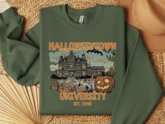 Celebrate Halloween in style in this retro Halloween town sweatshirt. Perfect for all Halloween lovers who like to combine vintage and scary elements. Get this sweatshirt and spread the festive spirit, whether you're trick-or-treating or attending a Halloween party.  ♥ PRODUCTION TIME: 1-5 days (Usually 2-3 days)  ♥ SHIPPING TIME: 2-5 days (Usually 3 days)  ♥ PRODUCT DESCRIPTION: Unisex Heavy Blend™ Crewneck Sweatshirt Gildan 18000 Made with a medium-heavy fabric blend of 50% cotton and 50% polyester (8.0 oz/yd² (271.25 g/m this sweatshirt feels cozy and is the perfect choice for those colder months. The classic fit along with the crew neckline deliver a comfy wearing experience with a clean-cut style. Meanwhile, the double-needle stitching at the shoulder, armhole, neck, waistband, and cu Teacher Sweatshirt, Halloween Lovers, Sweatshirt Vintage, Fall Shirt, Halloween Town, Retro Halloween, Halloween Sweatshirt, Clean Cut, Fall Shirts