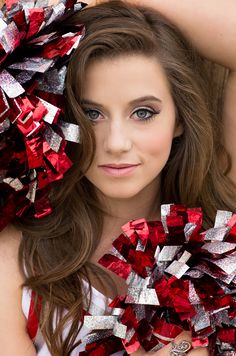 a girl in red and silver is posing for the camera