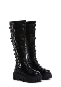 in a vegan leather construction. These knee high boots have decorative buckles on both sides, treaded soles, and back zipper closures. Thigh High Purple Boots, Gothic Leather Knee-high Boots, Gothic Leather Knee-high Boots For Alternative Fashion, Leather Knee-high Boots With Round Toe For Alternative Fashion, Edgy Knee-high Boots With Buckle Closure, Edgy Knee-high Moto Boots With Buckle, Edgy Knee-high Moto Boots With Buckle Closure, Fall Knee-high Boots For Alternative Fashion, Fall Season Knee-high Boots For Alternative Fashion