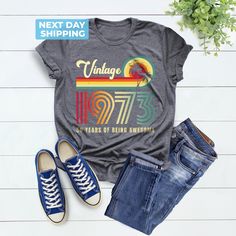 Vintage 1973 50 Years of Being Awesome Shirt, 1973 Unisex Shirt, 1973 Birthday Shirt, Vintage 1973 Shirt, Vintage 1973 Tee, Retro 1973 Shirt Hi! Welcome to the LaTeeApparel!  It's great to see you here! Our shirts are clean, high quality and soft. It is prepared quickly by our store! Enjoy your shopping! It is a pleasure for us to help you with your questions and you can reach us at any time. F I T  ∙ S I Z I N G  -->Women's sizes are narrower than the waist -->Sleeves are rolled up in some prod Vintage Crew Neck Shirt For Birthday, Vintage Letter Print Tops For Anniversary, Vintage Cotton Tops For Anniversary, Vintage Short Sleeve Tops For Birthday, Retro Birthday Shirt With Graphic Print, Retro Graphic Print Tops For Anniversary, Vintage Graphic Print Top For Birthday, Retro Summer Tops For Anniversary, 50 Years Of Being Awesome