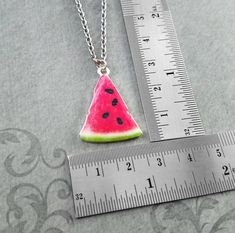 "This listing is for a watermelon slice charm necklace. You'll be able to choose your chain length and style at checkout by using the \"Chain Length/Style\" drop-down menu. Keyrings, bangle bracelets, ball chains, and black/brown leather and suede cord are also available. **Please see the second photo for scale! If you're on the mobile site, just swipe to the side. :) - - - - - - - Sign up for our newsletter to receive coupons and updates on new items! Follow the link: ♦ ♦ ♦ http://eepurl.com/cG Watermelon Colored Summer Jewelry Gift, Summer Watermelon Colored Jewelry For Gift, Handmade Watermelon Colored Jewelry For Gift, Handmade Watermelon-colored Jewelry Gift, Summer Nickel Free Necklaces As Gift, Nickel-free Necklaces As Summer Gifts, Nickel Free Necklaces As Summer Gift, Adjustable Watermelon Colored Jewelry For Gifts, Adjustable Watermelon Colored Jewelry Gift