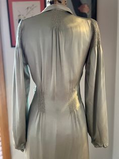 A very Hollywood glamour style robe from the 1930s. Exquisitely made with two layers of silk. In a celadon green, the outer layer is a silk satin, the inner is a crinkled silk chiffon.  Both layers feature expertly done ruching at the top of the balloon sleeves, at the back neck, the waist front and back,  and at the side tie area.  A wide collar, side tie sash and a fishtail train at rear.   Even left open the gown looks wonderful.  See last photos.  In excellent condition bar the following iss Fitted Green Silk Long Sleeve Dress, Fitted Green Silk Dress For Wedding, Green Fitted Silk Wedding Dress, Glamour Style, Celadon Green, Silk Robe, Pajama Robe, Hollywood Glam, Womens Robes