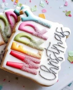 two decorated cookies sitting on top of a white plate