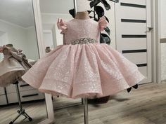 This gorgeous sparkling dress will turn your baby into a real princess. The dress is made of a shiny fabric of pale pink color. The waist of the dress is decorated with a decorative detail of rhinestones. Sleeveless dress. The back of the dress has a V-neck. The inside of the dress has a lining, all seams are closed. As is typical for any shiny fabric - there is a small scattering of sequins on it, which is not a defect. The dress is knee-length, but at your request can be sewn floor-length (ext Pink Princess Dress With Sequins For Wedding, Pink Sequin Princess Dress For Wedding, Pink Embellished Princess Dress For Dress-up, Pink Glitter Tulle Sequin Dress For Dress-up, Pink Sequin Dress With Glitter Tulle For Dress-up, Pink Princess Sequin Dress For Weddings, Pink Princess Dress With Sequins For Pageant, Pink Sequined Princess Dress For Pageant, Pink Sequined Pageant Dress For Party