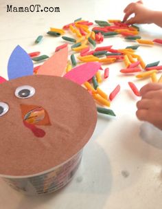 a child is making a turkey out of construction paper