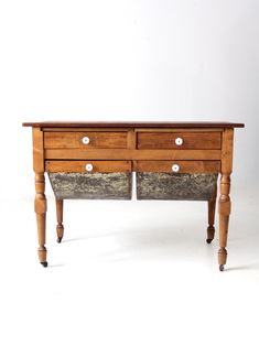 an old wooden table with two drawers on one side and three smaller drawers on the other