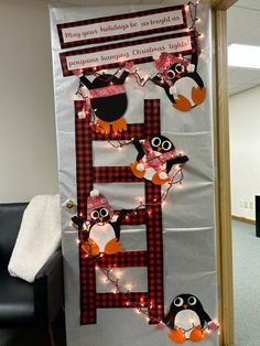 a bulletin board decorated with penguins and lights