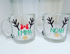 two glass mugs with reindeer antlers and name on the front one has a bow