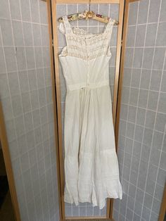 "Early 1900's white cotton petticoat dress. Buttons up the back, lace eyelet straps, large rip and stain spot. A couple of other small rips, being sold as is Bust: 34/35\" Waist: 25\" Hips: up to 47\" Armpit to hem: 45\"" White Cotton Victorian Dress For Summer, Summer Cotton Victorian Dress, Summer Victorian Cotton Dress, White Victorian Vintage Summer Dress, Summer Vintage Dress In White For Daywear, White Victorian Dress For Summer, Victorian Cotton Summer Dress, Victorian Style Cotton Summer Dress, Victorian Cotton Dress For Summer