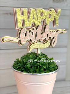 a happy birthday cake topper sitting on top of a potted plant