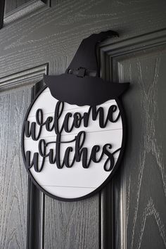 welcome witches sign hanging on the front door