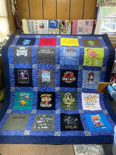 there is a blue quilt with many different patches on it