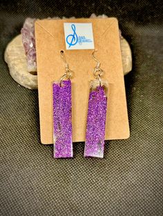 These one-of-a-kind sparkly narrow rectangle panel resin earrings are colored with violet microglitter, sanded smooth, and assembled on silver plated ear wires. Perfect for a night on the town or a day at the office, these earrings will become your go-to when you need a lightweight pop of color. Purple Glitter Jewelry For Gifts, Purple Glitter Earrings For Gift, Purple Glitter Jewelry Gift, Purple Rectangular Jewelry For Party, Diy Resin Projects, Resin Projects, Crystal Prisms, Diy Resin, Resin Earrings