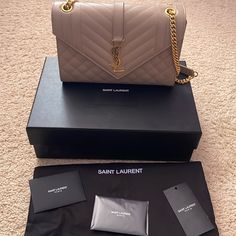 Authentic Ysl Triquilt Medium Shoulder Bag In Dark Beige. This Includes The Ysl Box, Dust Bag, And Receipt. Can Be Worn As A Shoulder Bag Or Crossbody. Retails For $2950. Timeless Envelope Flap Bag In Grain De Poudre Embossed Leather, Featuring Chevron And Diamond Quilt Overstitching. Versatile Bag With An Adjustable Sliding Chain. Chrome And Metal-Free Tanned Leather Grosgrain Lining Light Bronze Brass Hardware One Exterior Back Pocket Magnetic Snap Tab One Interior Slot Pocket Dimensions: 9.4 Ysl Box, Line Light, Dark Beige, Diamond Quilt, Flap Bag, Brass Hardware, Embossed Leather, Chain Length, Yves Saint Laurent