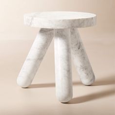 a white marble stool with three legs