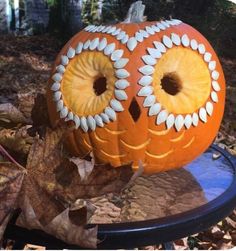 a pumpkin with an owl face painted on it