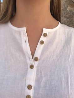 "Gorgeous loose linen shirt with buttons down the front. Simple and feminine silhouette with 3/4 sleeves. An item in your wardrobe that will prove itself as a timeless value. Will suit you perfectly for a day on the beach just as well as a city stroll. An airy and light top to wear. Great comfort provided by the loose, extra long cut and fantastic linen. The rear of the shirt is curved and longer than the back. You can choose different colours from the light and medium light linens. All fantasti Bohemian Long Sleeve Linen Shirt, Beach Linen Shirt With Buttons, Summer Long Sleeve Blouse With Buttons, Bohemian Blouse With Buttons For The Beach, Bohemian Beach Blouse With Buttons, White Linen Tops With Buttons, White Linen Top With Buttons, White Linen Bohemian Shirt, White Bohemian Shirt For Daywear