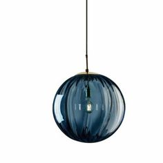 a blue glass light hanging from a ceiling