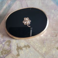 My best guess is that this is a Victorian piece, but I cannot guarantee that. This is a vintage, signed WL, 14 Karat gold, black onyx and seed pearls, shamrock, mourning brooch or pin. There is a stamp on the closure of the clasp. This piece has also tested positive for 14 Karat gold. All sales are final. This measures 31 mm x 21 mm. If you have a wish list or are looking for something specific, please ask. I may have exactly what you are looking for. As always please convo me with any questions or concerns regarding this item or with any international shipping questions. Unfortunately I do not accept returns or grant refunds. All shipping fees include handling fees. If you would like to combine shipping costs for more than one item, I would be happy to do so if you convo me before purchas Seed Pearl, Cute Rings, Wish List, Black Onyx, Gold Black, Clip On Earrings, Jewelry Necklace Pendant, Onyx, Seeds