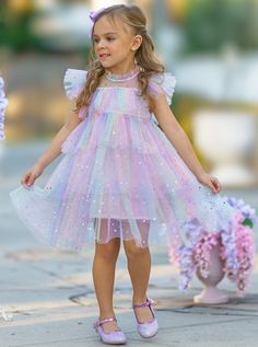 Your precious girl will look and feel like an enchanting princess in this magical tiered ruffle dress. Decorated with moon and star sequins, this rainbow number will have her shining and beaming with joy with every step!  Lightweight fabric feels good on her skin, keeping her cool and comfy even on warm summer days. Re Unicorn Dresses For Kids, Unicorn Dresses, Bday Dress, Kid Birthday Outfits, Toddler Birthday Dress, Star Sequins, Mermaid Theme Birthday Party, Princess Dress Kids, Pastel Girl