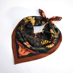 a black and orange scarf with flowers on it