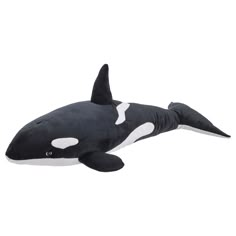 an orca whale stuffed animal laying on its back with it's mouth open