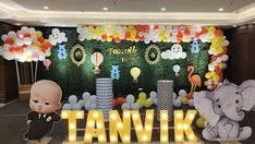 an image of a birthday party with balloons and decorations on the wall in front of it