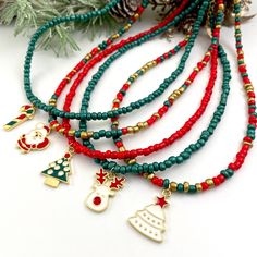 "Beautiful and delicate Christmas Beaded Necklaces, decorated with cute Christmas charms. You can choose your favorite charm and your necklace color and create the perfect necklace for yourself. Enhances your Holiday outfit by wearing these cute seed bead necklaces. ♥ ITEM DETAILS: Total Length: 14 - 15 - 16 - 17 - 18 inches. The length of the necklace refers to the total length from end-to-end. Materials:  Seed beads - Enamel charms - 18K Gold plated. Color necklace available: #1 Red - #2 Green Christmas Beaded Necklace Ideas, Diy Christmas Necklace Ideas, Christmas Necklace Beads, Christmas Jewelry Diy Necklace, Christmas Necklace Ideas, Christmas Seed Bead Bracelets, Christmas Accessories Jewelry, Christmas Necklace Diy, Christmas Beaded Jewelry