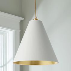 a white and gold light hanging from a ceiling fixture in a living room or bedroom