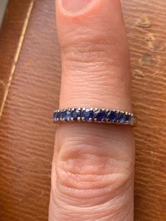 Marked: 750, KC or KO, 2183 / 2233 Front measures: 3.13mm to 2.8mm Band measures 2.71mm to 1.74mm Weight: 3.04 grams Size: 6.5 to 6.75 (in between sizes) Natural blue sapphires, tested by a gemologist. Condition: some light wear, some sapphires have a few chips and abrasion. Metal has some wear. Formal Sapphire Half Eternity Rings, Timeless Hallmarked Sapphire Ring, Round Sapphire Gemstones For Anniversary, Sapphire Gemstones For Anniversary, Classic Sapphire Ring Half-eternity, Classic Sapphire Ring Stamped 14k, Blue Half Eternity Round Ring, Classic Blue Half Eternity Ring, Classic Half Eternity Sapphire Ring