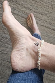 This beachy, summery handmade macrame beaded anklet is suitable for all ages. It is made using natural cotton cord adding toho seed beads in light blue and gold purple. It is finished with a silver bead for the clasp and beaded fringes that hang nicely for an added touch.  Macrame forms a firm band take care of it, in that I suggest not getting it wet to preserve the beads, and it will last a long time.  Please measure your ankle around the ankle bone, not too tight, not too loose.  This piece can be done using different colors of beads or one solid color.  If you have any trouble with your order, please be sure to message me so I can make it right. Macrame Anklet, Beaded Anklet, Pretty Legs, Ocean Jewelry, Handmade Macrame, Beaded Anklets, Ankle Bones, Beaded Fringe, Silver Bead