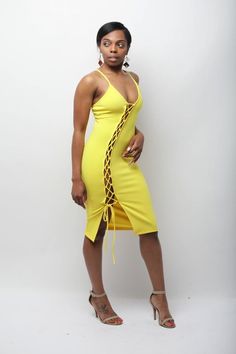 Yellow lace up dress can be untied at the bottom, and it is an easy pull over. Material: 96% polyester/4% spandex Model is wearing a size small.