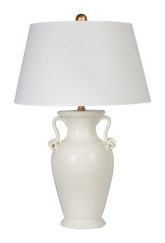 a white table lamp with a white shade on it