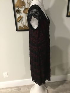 "Pretty black lace slip dress. Has a stretchy maroon colored lining and overlapping layers of lace on the outer layer. Cute black bead detail added. Has v necks on front and back and cap sleeves. The Label reads Blu Sage size 14, but please see measurements below to ensure a good fit. Note: this dress is newer than I usually feature...but I think it has a good look and it is definitely vintage inspired. Measures: 35\" bust; 34\" waist; 38\" hips; 43\" hemline; 41\" tall. Outer layer is 94% nylon Sheath Lace Dress With Lace Trim For Evening, Burgundy Lace Evening Dress, Fitted Lace Burgundy Dress, Elegant Black Slip Dress With Lace Trim, Vintage Sleeveless Lace Slip Dress, Black Lace Slip Dress, Elegant Black Lace Trim Slip Dress, Black Lace Trim Camisole Slip Dress, V Necks